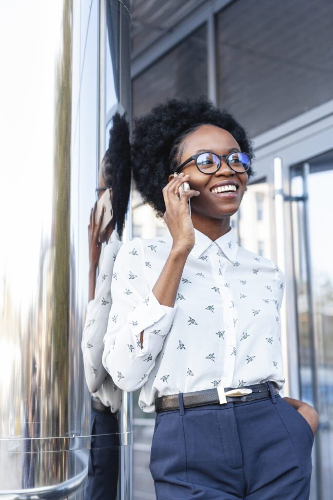 low angle smiley female talking phone